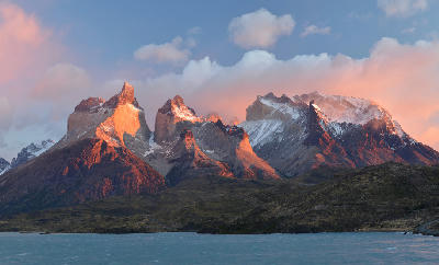 Cuernos del Paine mountains glowing at sunrise above Lago Pehoé in Torres del Paine National Park, Chile.