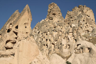 Close-up of Uçhisar Castle in Cappadocia, Turkey, showing the rock-cut cave dwellings carved into the volcanic fortress.