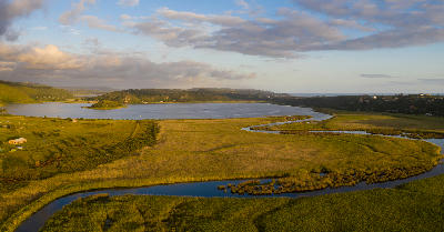 Aerial view of the Serpentine River meandering through reed-filled wetlands beside Island Lake near Wilderness on the Garden Route.