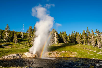 Riverside Geyser eruption rainbow Firehole River