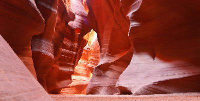 Narrow sandstone passage inside Upper Antelope Canyon with curved walls and soft reflected light
