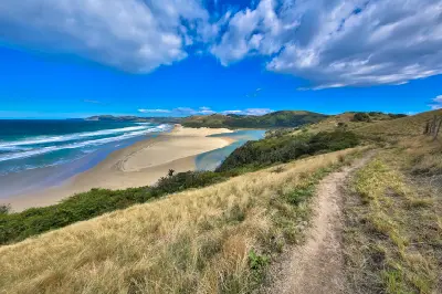 Mbotyi River Mouth estuary, beach and coastal hills viewed from an elevated hillside on the Wild Coast, Eastern Cape, South Africa.