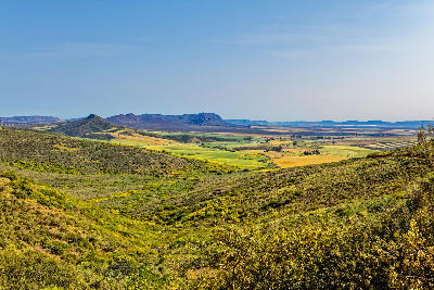 Panoramic view of green foothills, farmland and distant mountains near Clanwilliam in the Cederberg Foothills of the Western Cape, South Africa.