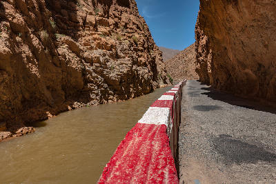 Road running beside the river through the canyon walls of Dades Gorge Road in Morocco
