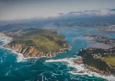 Aerial view of the Knysna Heads and estuary, showing the narrow channel connecting the Knysna Lagoon to the Indian Ocean along South Africa's Garden Route.