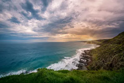 Rugged Cape Otway coastline overlooking the Southern Ocean beneath dramatic evening clouds in Victoria.