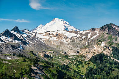 Mount Baker snow covered volcanic peak in Washington Cascades USA with alpine ridges and forest foreground