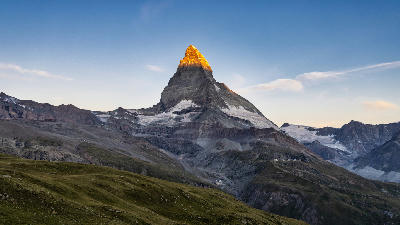 Matterhorn peak at sunrise with alpenglow on the summit, Zermatt, Switzerland.