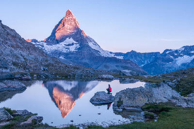 Matterhorn reflected in Riffelsee at sunrise with alpine foreground, Switzerland.