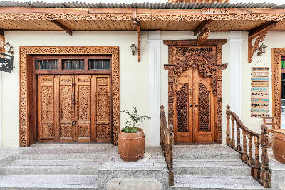 Intricately carved wooden doors on historic buildings in Stone Town, Zanzibar, showcasing traditional Swahili craftsmanship.