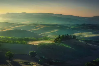 Summer morning in Tuscany. Podere Belvedere iconic view at sunrise, a beautiful light over the rolling hills in Val d'Orcia.