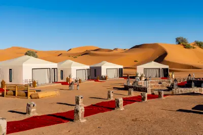 Luxury desert camp tents beside the sand dunes of Erg Chebbi in Merzouga, Morocco.