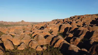 Elevated view across the densely packed orange-and-black striped sandstone domes of the Bungle Bungle Range.