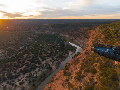 Kalbarri Skywalk extends over the Murchison River gorge in warm evening light.