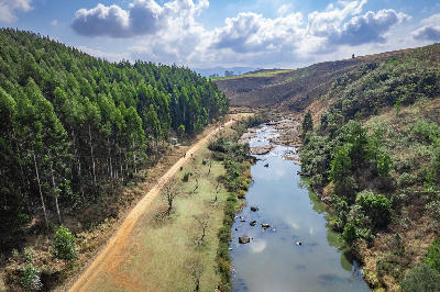 Aerial view of the Karkloof River flowing through forest plantations and farmland in the Karkloof Valley near Howick, KwaZulu-Natal, South Africa.