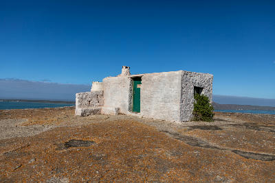 Historic stone shepherd's cottage at Seeberg Viewpoint overlooking Langebaan Lagoon in West Coast National Park, South Africa.