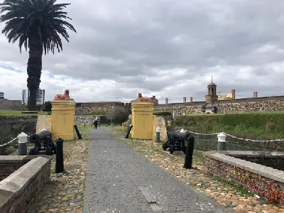 Entrance bridge to the Castle of Good Hope with lion statues and cannons in Cape Town, South Africa.