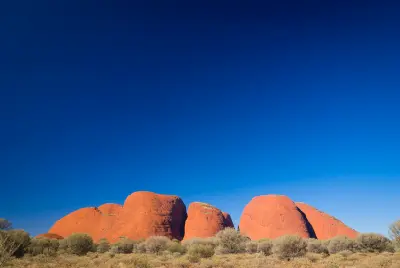 Red sandstone domes of Kata Tjuta above desert scrub in Uluru-Kata Tjuta National Park, Australia.