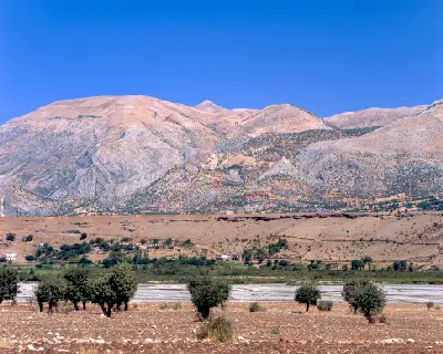 Mount Nemrut rising beyond the rural landscape and valley as seen from Karakuş Tumulus in Adıyaman, Turkey.