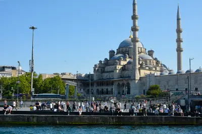 Yeni Camii New Mosque and crowds along the Golden Horn waterfront at Eminönü, Istanbul.