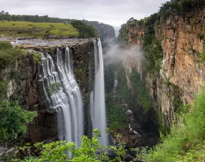 Magwa Falls cascading over a cliff into a narrow forested gorge on the Wild Coast of the Eastern Cape, South Africa.
