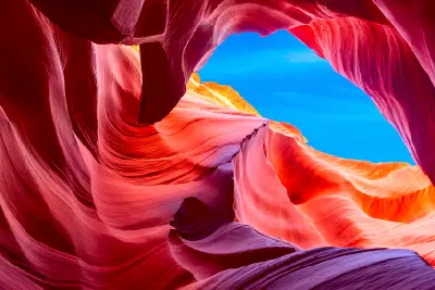 Upper Antelope Canyon swirling sandstone formations with sky opening above, Page, Arizona, USA