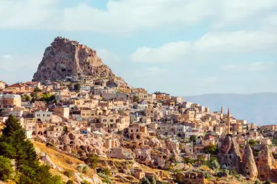 Uçhisar in Cappadocia, Turkey, showing rock-cut houses set into volcanic formations with Uçhisar Castle above the surrounding landscape.