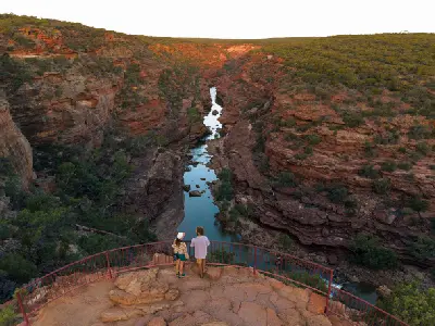 Visitors overlook the Murchison River winding through the red sandstone gorge in Kalbarri National Park.