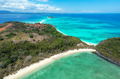 Drone photograph of Nosy Iranja, Madagascar, showing tropical coastline, turquoise lagoon water, white beaches, and the famous sandbank extending into the Indian Ocean.