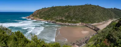 The historic Kaaimans Railway Bridge spans the Kaaimans River Mouth near Wilderness, where the estuary meets the Indian Ocean along South Africa's Garden Route.