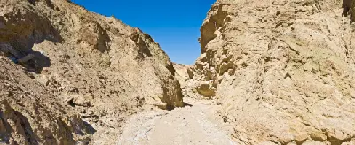 Golden Canyon narrow passage Death Valley with limestone walls leading toward Red Cathedral below Zabriskie Point