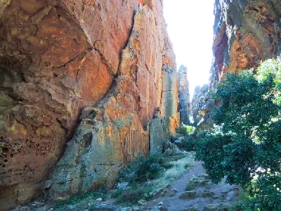 Towering sandstone walls and a narrow hiking passage within Wolfberg Cracks in the Cederberg Wilderness Area, Western Cape, South Africa.