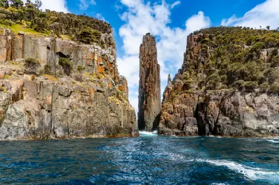 Dramatic dolerite sea cliffs and narrow rock pillars rising from the ocean at Cape Hauy, Tasmania.