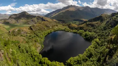 Diamond Lake surrounded by forest below the Diamond Lake Track viewpoint near Wānaka, New Zealand.
