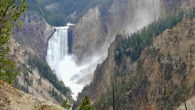 Lower Falls of the Yellowstone River from Artist Point with mist rising through canyon walls