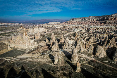 Aerial view of fairy chimneys and eroded rock formations across Pigeon Valley, Cappadocia, Turkey.