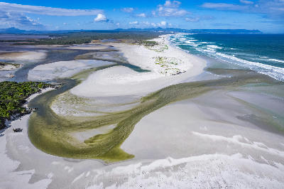 Aerial panorama of Grotto Beach in Hermanus showing tidal estuary patterns, white sand beaches, turquoise ocean waves, and coastal dune systems along the Overberg Whale Coast in South Africa.