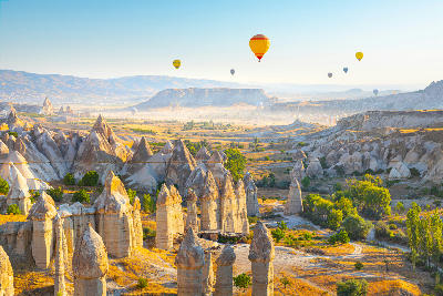 Love Valley seen in a panoramic view near Göreme, showing eroded rock formations across the valley landscape in Cappadocia, Turkey.