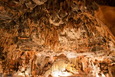 Intricate limestone ceiling formations and illuminated stalactites inside the Throne Room chamber of the Cango Caves near Oudtshoorn in South Africa.