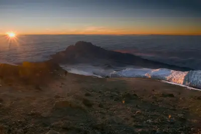 Sunrise near Uhuru Peak on Mount Kilimanjaro with glaciers, Mawenzi Peak and a sea of clouds, Tanzania.