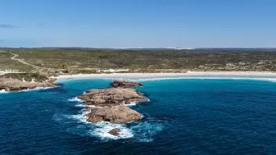 Aerial view of offshore granite rocks, turquoise water and white sand at Twilight Beach near Esperance, Western Australia.