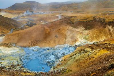 Colourful geothermal valley with steaming vents and blue hot pools at Seltún in Krýsuvík on the Reykjanes Peninsula, Iceland.