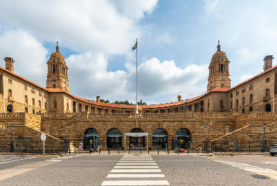 The Union Buildings in Pretoria viewed from the main entrance, with twin sandstone towers, the national flag and grand colonnades dominating the façade.