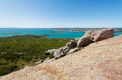 Granite outcrops overlooking Langebaan Lagoon from Seeberg Viewpoint, with turquoise waters, islands and coastal landscapes in West Coast National Park, South Africa.