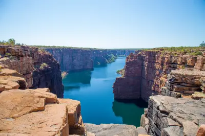 Deep blue waters of the King George River wind between towering red sandstone cliffs in the Northern Kimberley.