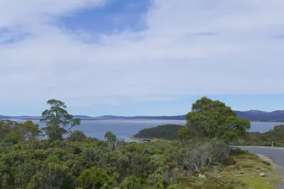 Great Lake surrounded by highland vegetation and distant hills on Tasmania’s Central Plateau.