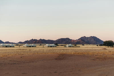 Desert campsite and mountain landscape near Sesriem in Namib-Naukluft National Park, Namibia.