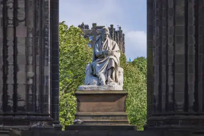 Statue of Sir Walter Scott and his dog Maida beneath the Gothic arches of the Scott Monument in Edinburgh.