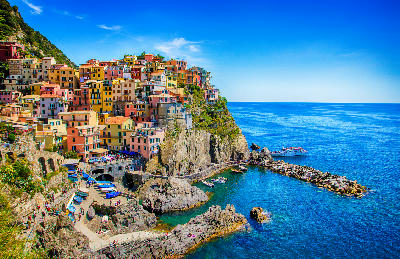 Cliffside colourful houses in Manarola, stacked above the Ligurian Sea in Cinque Terre, Italy.