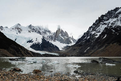 Laguna Torre with floating ice and Cerro Torre peaks under overcast skies in Patagonia, Argentina.